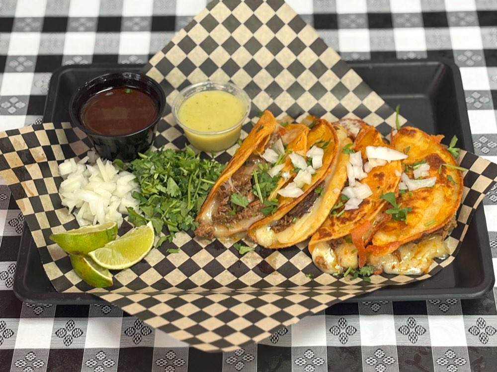 Quesabirria tacos with melted Monterrey Jack cheese and consomé