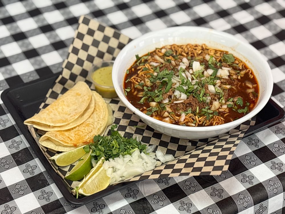 Bowl of birria ramen noodles in consomé with beef birria meat