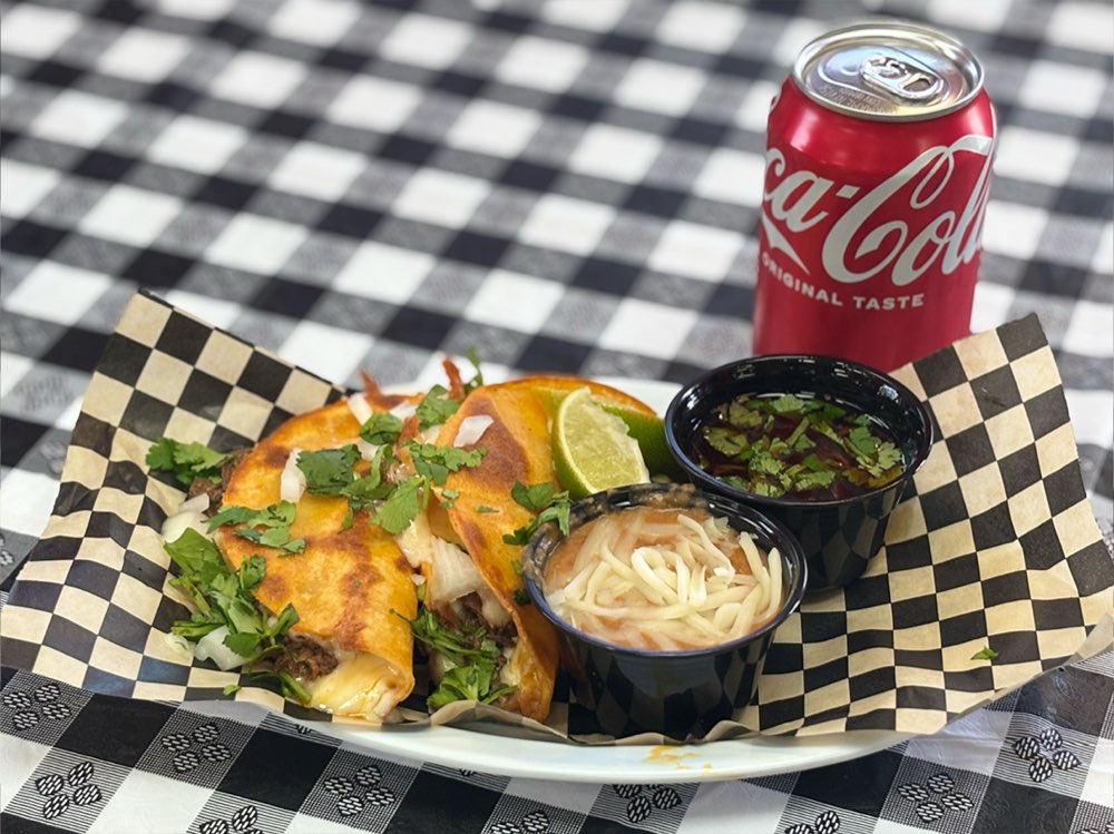 Weekday lunch special with two tacos, consomé, and beans